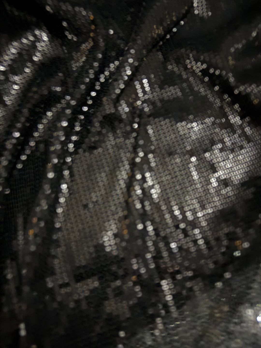 Black Allover sequin fabric on fine stretch knit.