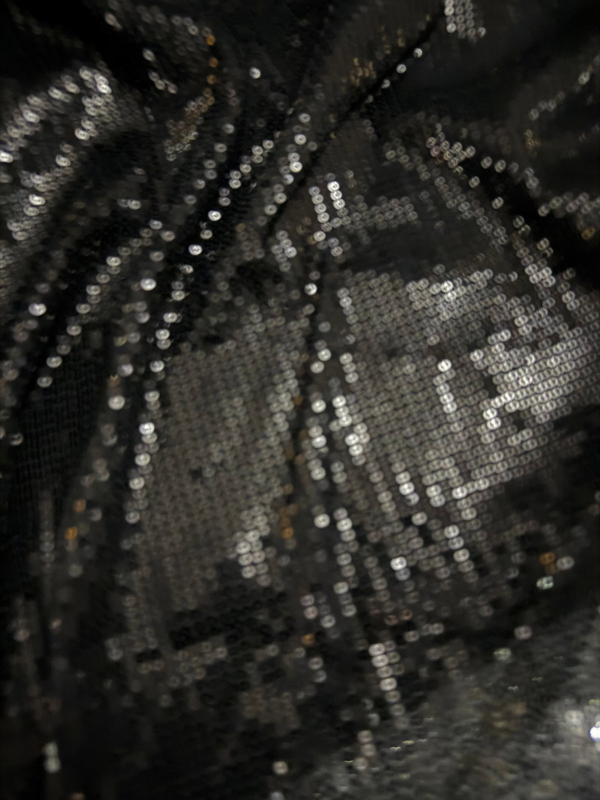Black Allover sequin fabric on fine stretch knit.